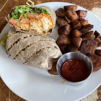 Buffalo cauliflower wrap and home fries￼  at Iron Roost in Ballston Spa