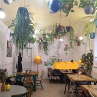The café from the inside (with a baguette over some strangers' faces for privacy) at Geranium Caffe in Poznan