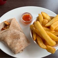 Chickenless chicken sweet chilli wrap and salt and pepper chips. The wrap tastes lovely; chips were stunning. at Phoenix Plant Based Eatery in Prescot