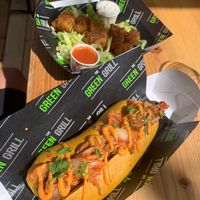 Kimchi dawg with spicy sriracha sauce. Sausage is made of seitan and in a turmeric bun. Banging flavours, maybe kimchi cut a bit smaller to be easier to eat. at The Green Grill - Walthamstow in East London