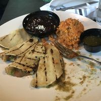 Vegetarian bean and cheese tacos grilled and served with black beans, rice, and green salsa. Delicious and so filling! My go-to.  at Cacao Restaurant in Kansas City