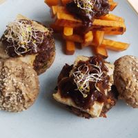 Veggie burger with homemade almond cheese and sweet potato  at Glow in Belgrade