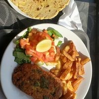 Ballo burger made gluten free (with chickpea flour chapati) best chipssss in miles! at The Laughing Buddha Cafe in Pushkar