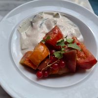 August 2025 - Heirloom tomato, coconut feta, cucumber, harissa, currants at Yes Yes Yes in Helsinki