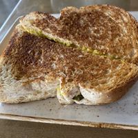 Grilled Cheese with pickles and tomato inside   at The Moth Cafe - Downtown in Edmonton