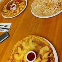 Apple dutch pancakes with rasberry sauce and almond and banana pancake with maple syrup at Pancakes - Prins Hendrikkade in Amsterdam