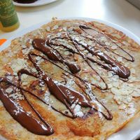 Vegan Dutch pancake with banana, chocolate sauce and almonds  at Pancakes - Prins Hendrikkade in Amsterdam