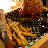 Grain bun, fries on the side. at La Bruja Vegan Foods in Antigua