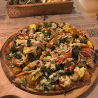 Build your own pizza with tofu cheese at La Bruja Vegan Foods in Antigua