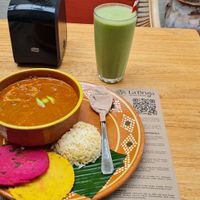 Traditional Pepian dish and golden green smoothie at La Bruja Vegan Foods in Antigua
