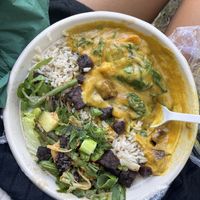 The Mix & Mingle bowl (vegan), half Asian-inspired salad with delicious tempeh, half sweet potato curry  at Stewart & Sally in Amsterdam