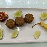 Sea falafels , pickle, and tomato skin flower filled with garlic chips. at Cafe Libre in Cuenca