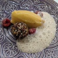 Coconut lemongrass foam, passionfruit banana gelato, and raw chocolate and nut ball. at Cafe Libre in Cuenca