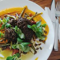Black lentil cutlet chop, great beans, carrot puree, fried pumpkin seeds at Pod Niebieniem in Poznan