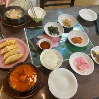 Top left: miso soup. Middle left: kimchi mandu. Bottom left: spicy tofu stew. On the right: side dishes    at Oh Se Gae Hyang - 오세계향 in Seoul