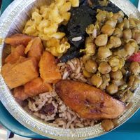 Sweet potatoes, rice and beans, curry chickpeas, jerk chicken, with mac and cheese. at Caribreeze in Spring Valley
