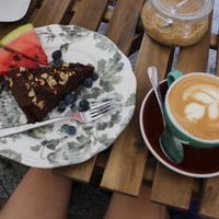 soy cappuccino and vegan brownie with fruit at W Filizance Cafe in Poznan