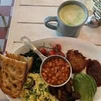 Full vegan English breakfast and oatmilk matcha latte  at STHLM Brunch Club in Stockholm