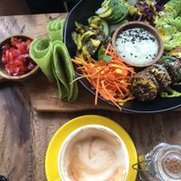 The "Let Us Falafel" salad bowl: sprouted and fried falafels coated in sesame gomashio with marinated aubergine, baby gem salad, house picked onion and red cabbage slaw. Served with tomato salsa, cashew tzatsiki, and grilled toritillas on the side.  at Two Trees Eatery in Tibubeneng