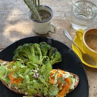 “Salm salm” but different-Smokey cured carrot on whole grain sourdough with cashew tofu tzatziki, pickled onions, watercress, cucumber, avocado, fresh dill +side grilled brocco at Two Trees Eatery in Tibubeneng