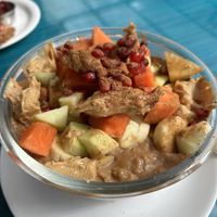 Oatmeal bowl with added fruits and peanut butterr  at Ira's Kitchen & Tea Room in Rishikesh