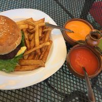 Lentil burger with vegan mayo, side sauces and homemade fries at Jardin La Reserva Restaurante in San Cristobal De Las Casas
