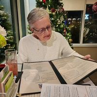 Perusing the menu  at Food For Thought in Williamsburg