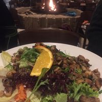 Fresh and huge vegan salad with grilled mushrooms in front of cozy fire place at Panorama in Winterberg