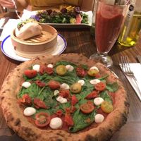 JB pizza and rejuvenator frozen smoothie, bao, and kale salad at Flax & Kale - Sant Pere Mes in Barcelona