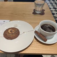 The biscuit with the coffee is not vegan  at Maison Marou Hanoi in Hanoi