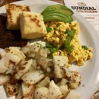 Vegan scrambled eggs, tempeh, home made muffins, and house potatoes 😋 at Sundial Cafe in Eugene