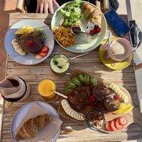 Pancake board, croissant, fresh orange juice and a breakfast menu on the other side   at Aloha Cafe in Sesimbra