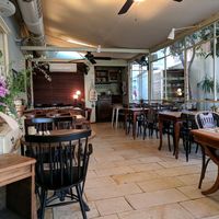 Enclosed outdoor dining at Meshek Barzilay Deli in Tel Aviv