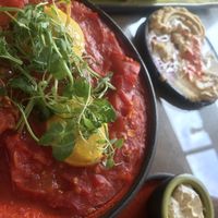 “Shakshuka” and lentil hummus served with freshly baked bread  at Kami Suites Hotel in Safed