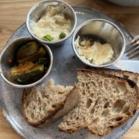 Bread with savoury spread, vegan butter and pickled cucumber  at Zaczyn in Krakow