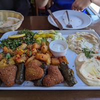 Vegetable mezze platter which is vegan apart from the yogurt dip. Falafel, stuffed fine leaves, Herby potatoes, hummus, baba ganoush, tabouleh, salad. at Mount Lebanon in Sheffield