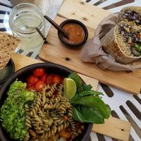 Mediterranean buddha bowl with pesto pasta, roasted veggies, tomatoes, spiced corn, greens with an olive sauce at Sapiens in Santiago