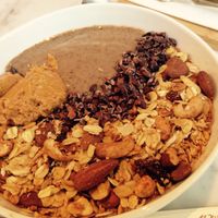 Smoothie Bowl wird toppings: cereal, Cacao and peanut butter  at My Goodness in Berlin