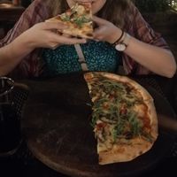 Happily eating the amazing Forrest Pizza at La Silapa in Luang Prabang
