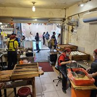 Seating in the back of the restaurant storefront at JinZhi Hong Zao Su Rou Yuan in New Taipei City