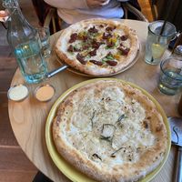 Glutenfree garlic sourdough with basil and maple sauce and “The One With The Nduja” pizza on the other side at Purezza Camden in London