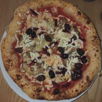 Four seasons pizza with cheese, olives, anchovies and mushrooms at Purezza Camden in London