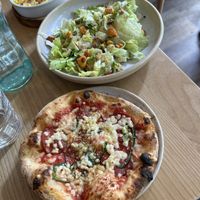 Vegan pepperoni individual pizza and side Caesar salad.   at Purezza Camden in London