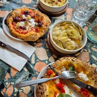 Mac and cheese, Four Cheese Pizza, roast potatoes, and Fuoco d’Amore Pizza. at Purezza Camden in London