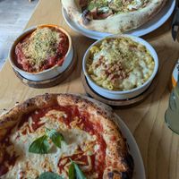 Margherita pizza, pistachio cream pizza, meatballs and Mac and cheese. at Purezza Camden in London