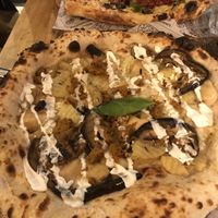 Couch potato pizza and roqueta pizza at the back. at Purezza Camden in London