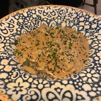 Ravioles rellenos de beyond meat con salsa trufada at Hakuna Matata Veggie in Madrid