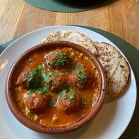 Vegan “meatballs” tajine with tomato sauce and pita bread at Hakuna Matata Veggie in Madrid