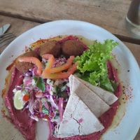 I had already started to eat before I took a photo, so that's why there is a bit missing. This is falafel with beetroot houmou, salad and flat bread. at Shady Lane in Mirissa