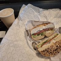 Everything bagel with green onion tofu schmear tomato red onion and lettuce and a vanilla latte with almond milk at Boss Bagel in San Antonio